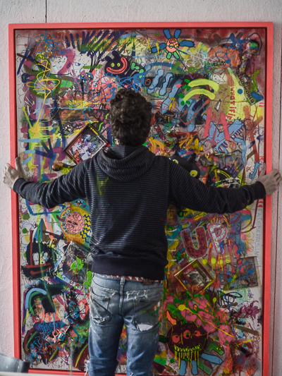 Bortusk hanging one of his canvasses