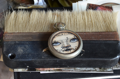 One of My Dog Sighs little faces on an old pocket watch case