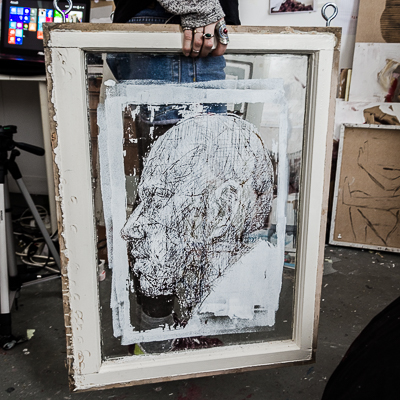 Inside Borondo's studio - Profile painted and scratched on an old window