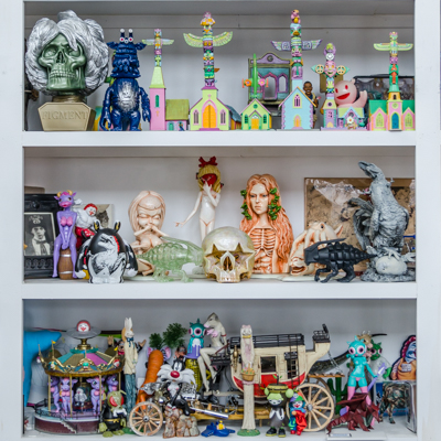 Inside Ron English's living room - shelves filled with toys and sculptures
