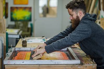 Screen Printing process - applying the ink on the screen with a squeegee