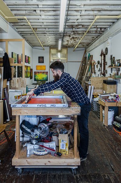 Beau Stanton coating the screen with magenta ink - the ink needs to be coated evenly in order to reveal the details of the print
