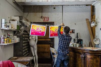Beau Stanton hanging the Leviathan two layers screen prints