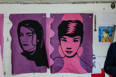 Irene Papas and Audrey Hepburn painted on textured table cloths waiting to be pasted in Päris - and on the right, portrait of young Marcel Pagnol, as part of the celebrations of the writer's birth 120 years ago
