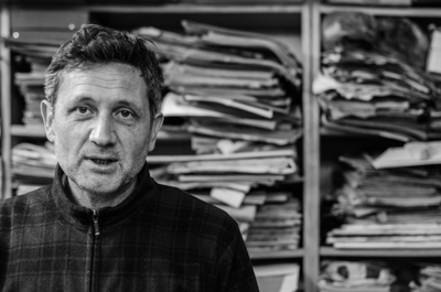 FKDL in his studio with his collection of magazines from the 1920's-1970's behind him